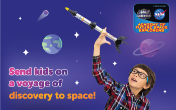 A boy playing with a model rocket from our NASA Academy of Future Space Explorers after-school program.